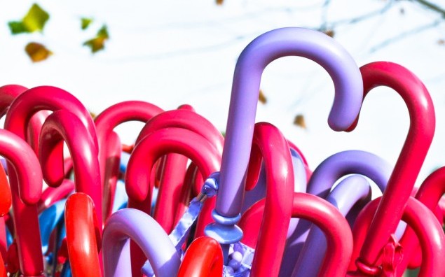 Stack of colorful umbrellas for sale at a stall