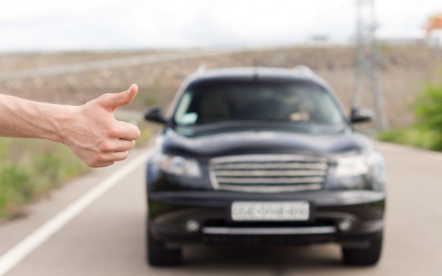 Man thumbing a lift at the roadside