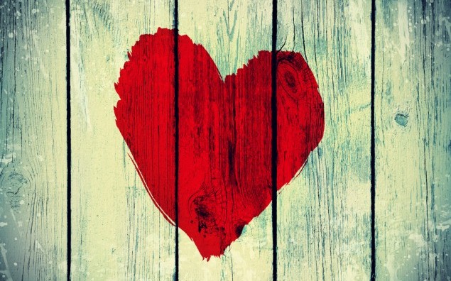 drawing love symbol on old wooden wall
