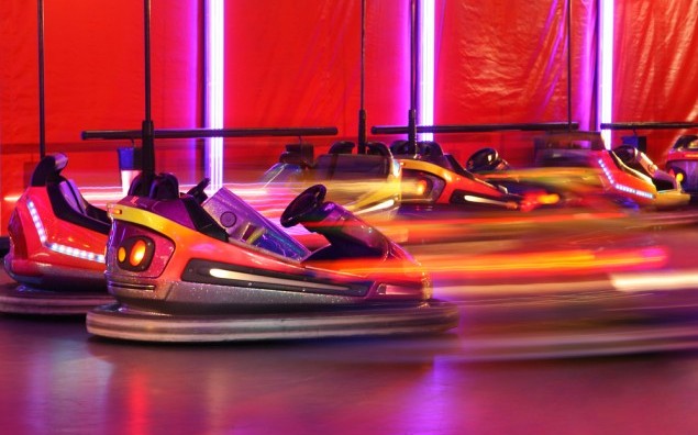 Bumper cars in motion in amusement park
