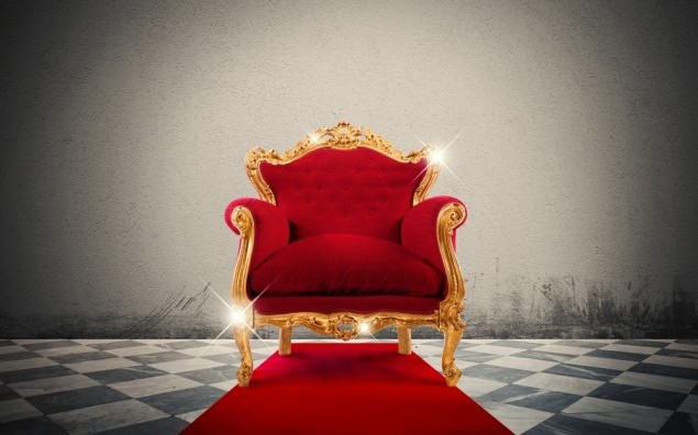 Sparkling golden armchair in a red carpet