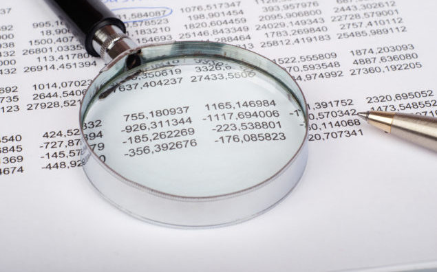 Hand glass on document