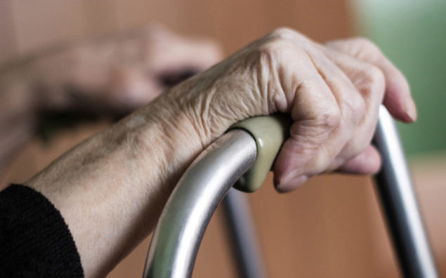 Elderly hands on a walker