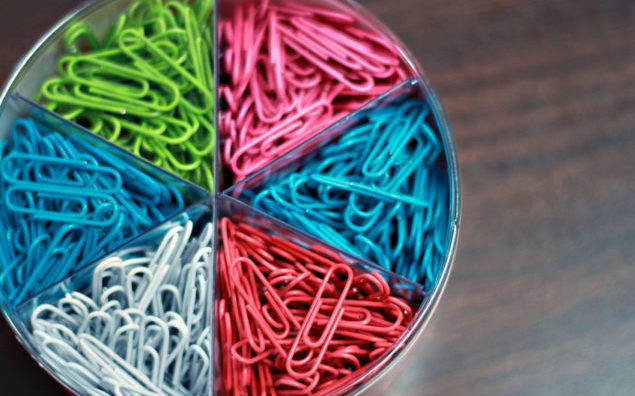 Brightly Colored Paper Clips Organized on Desk in Office