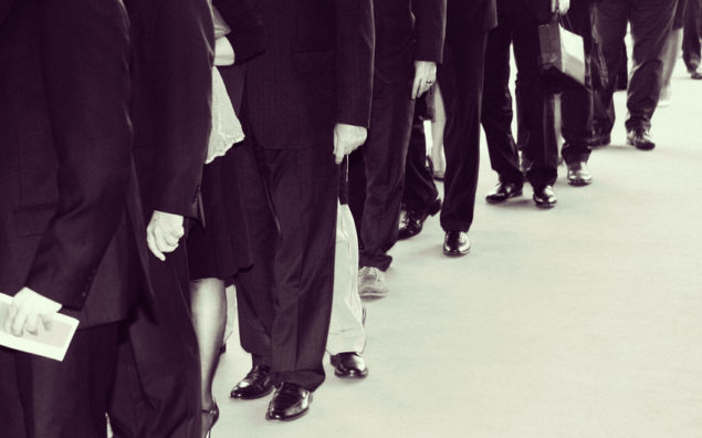 Suits waits in line. Retro black white with noise added