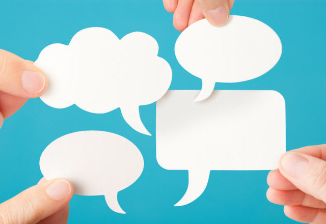Four blank white conversation speech bubbles