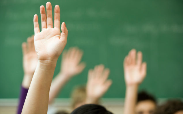 Hands raised in classroom