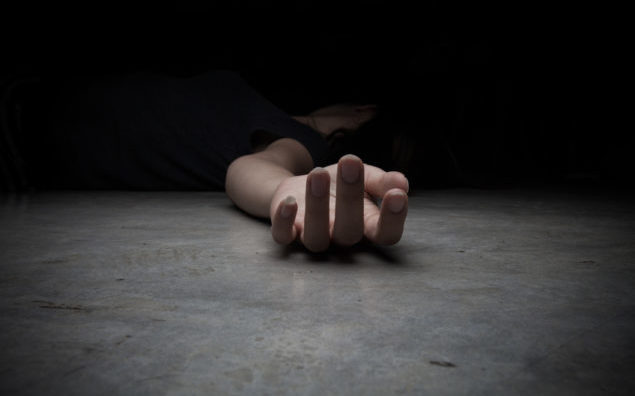 The dead woman's body. Focus on hand
